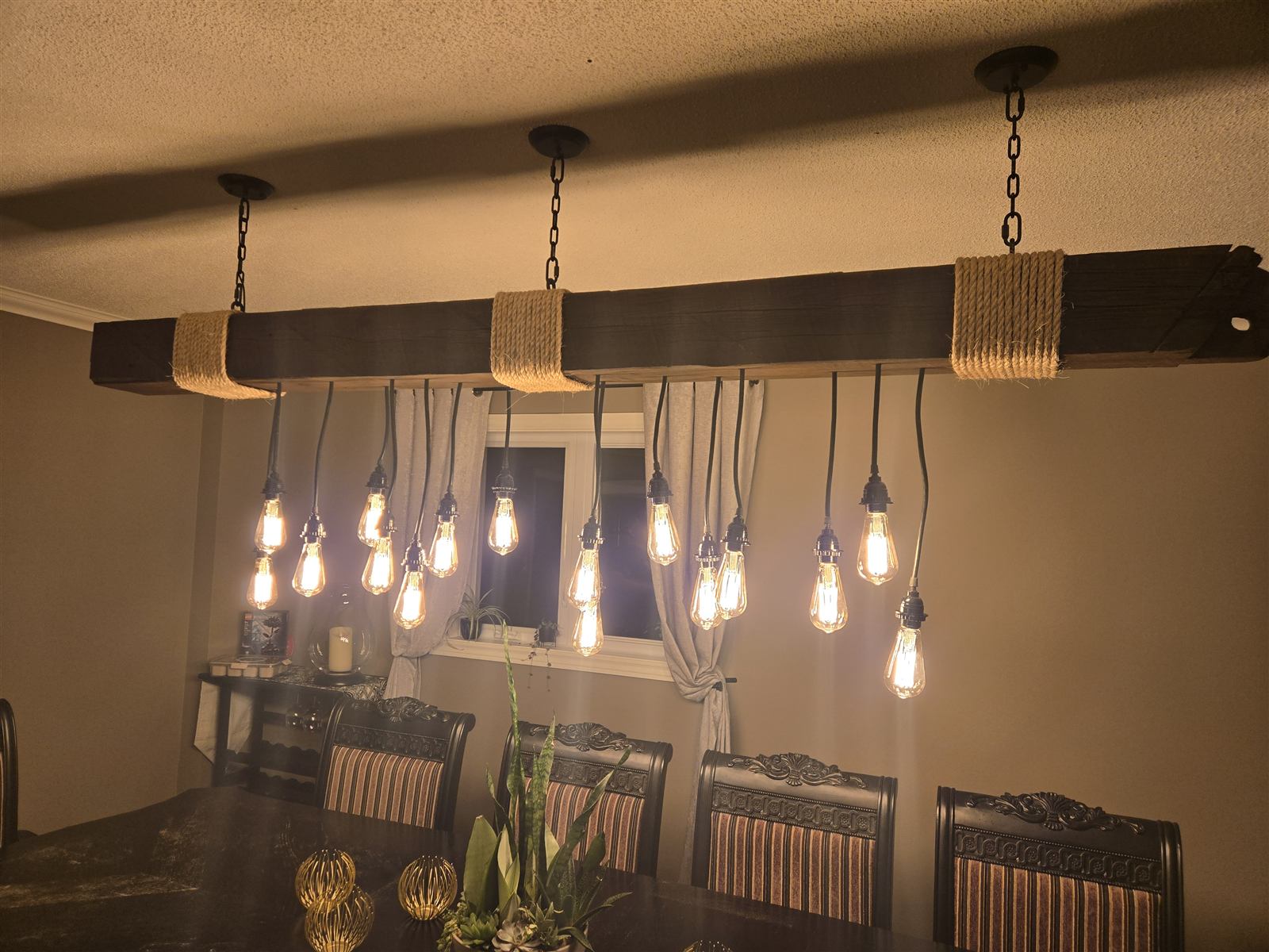 Wood fixture from below showing chain mounts and bulb spacing
